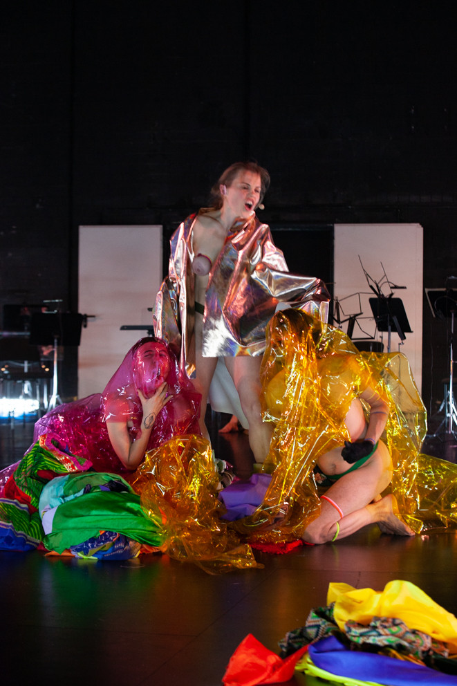 three people covered with colored foil